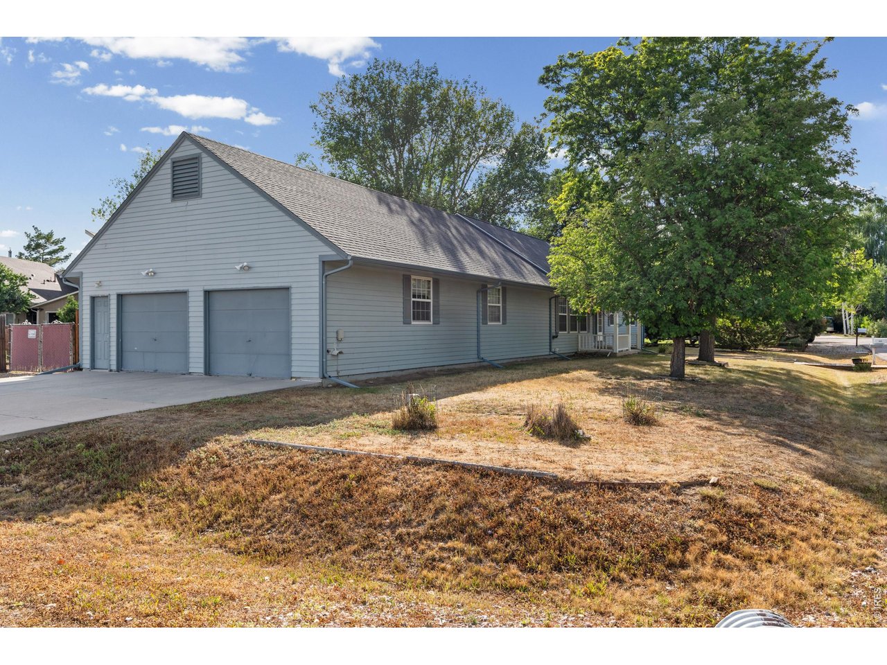 Property Photo 3 House sits on corner lot with extended garage and driveway easily accessible.