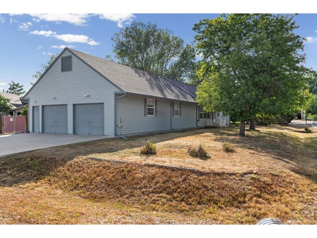 Property Photo 3 House sits on corner lot with extended garage and driveway easily accessible.
