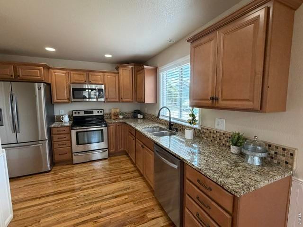 Property Photo 2 A beautiful open kitchen with alder cabinets, granite counters and tile backsplash