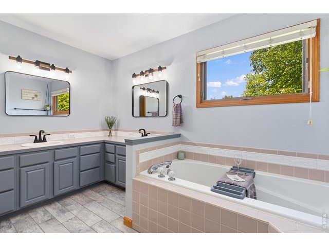 Property Photo 25 5-piece primary bathroom with updated fixtures
