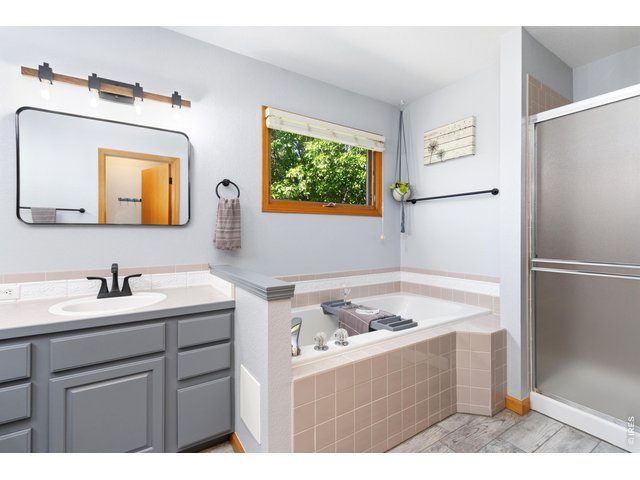 Property Photo 24 5-piece primary bathroom with updated fixtures