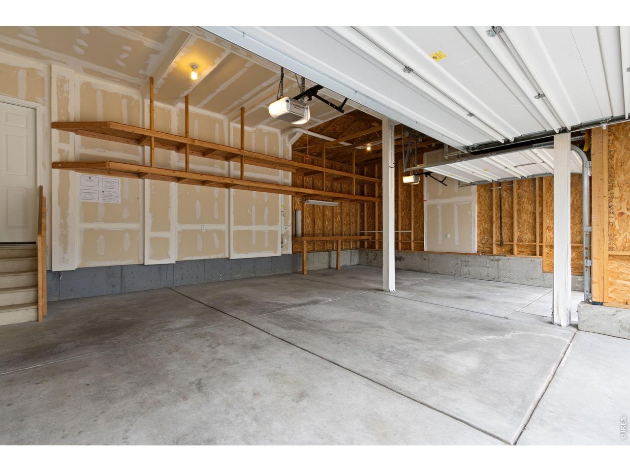 Property Photo 38 Garage with tall ceilings and lots of shelving