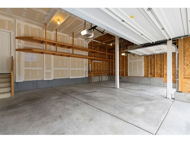 Property Photo 38 Garage with tall ceilings and lots of shelving