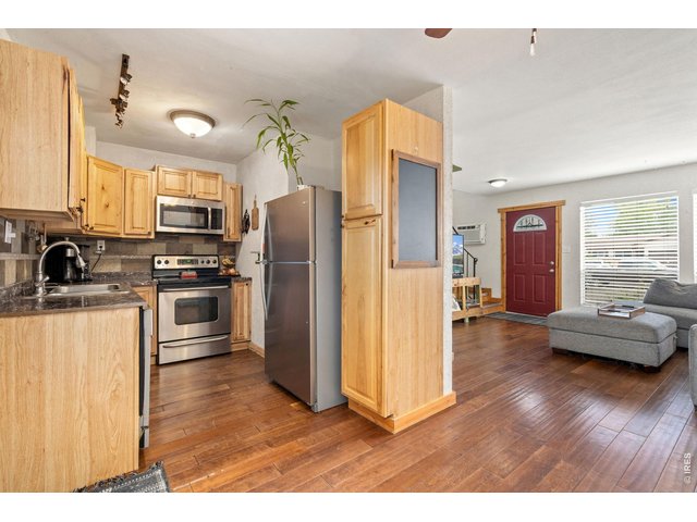 Property Photo 7 Updated kitchen with stainless appliances including a nearly new refrigerator. Hardwood cabinets!