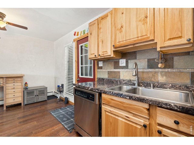 Property Photo 8 Updated kitchen with stainless appliances including a nearly new refrigerator. Hardwood cabinets!