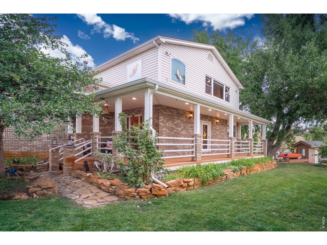 Property Photo 6 Wrap-around covered porch and mature landscaping greet you on 10.3 acres.