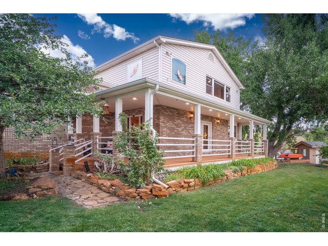 Property Photo 6 Wrap-around covered porch and mature landscaping greet you on 10.3 acres.