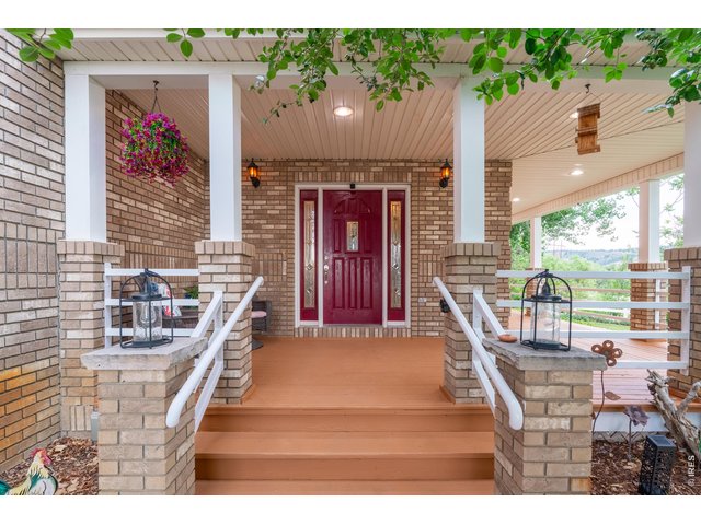 Property Photo 7 Brick columns and a deep covered porch frame the front entry.