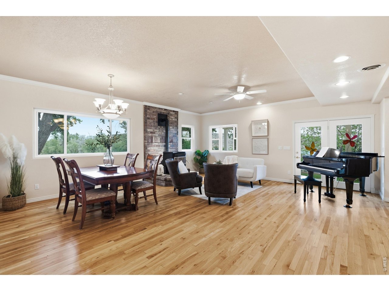 Property Photo 9 Hardwood floors run through the open living and dining area, warmed by a pellet stove.