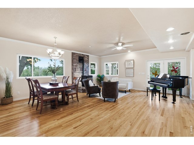 Property Photo 9 Hardwood floors run through the open living and dining area, warmed by a pellet stove.