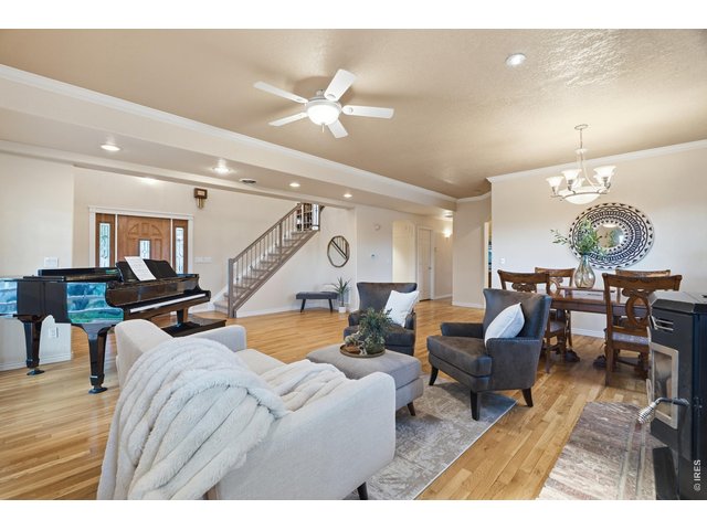 Property Photo 8 The open main level flows from entry to living and dining, with stairs to the upper level.
