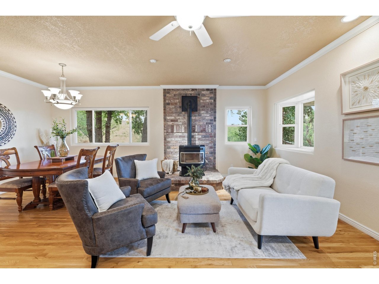 Property Photo 10 A brick hearth and pellet stove anchor the living room, with windows on three sides.