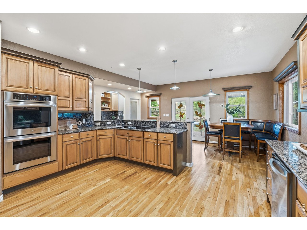 Property Photo 12 The granite peninsula and double ovens open directly to the breakfast nook.