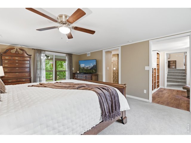 Property Photo 19 Primary bedroom with private access to a covered deck.