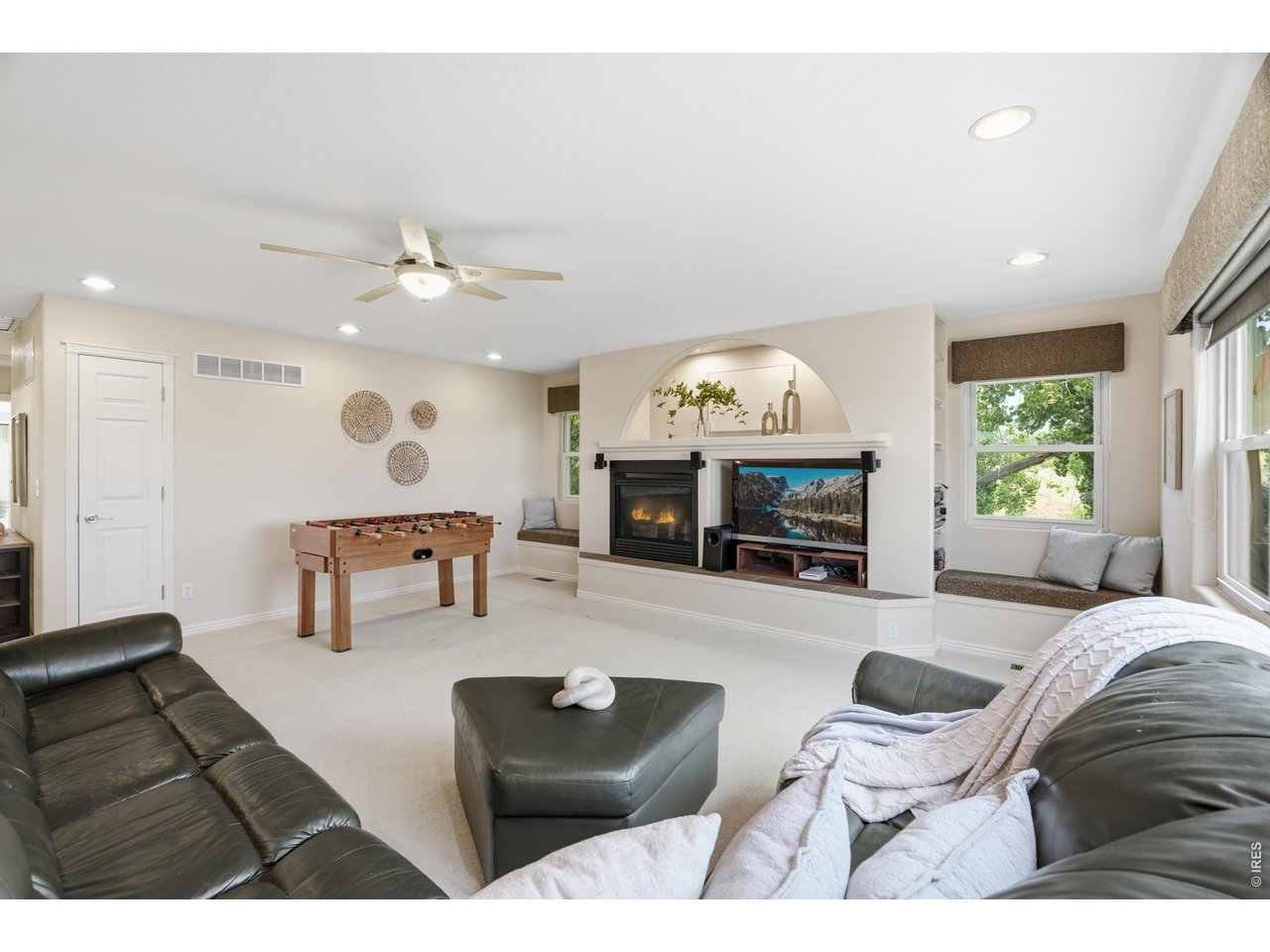 Property Photo 25 The upper-level loft centers on a gas fireplace flanked by built-in window seats.