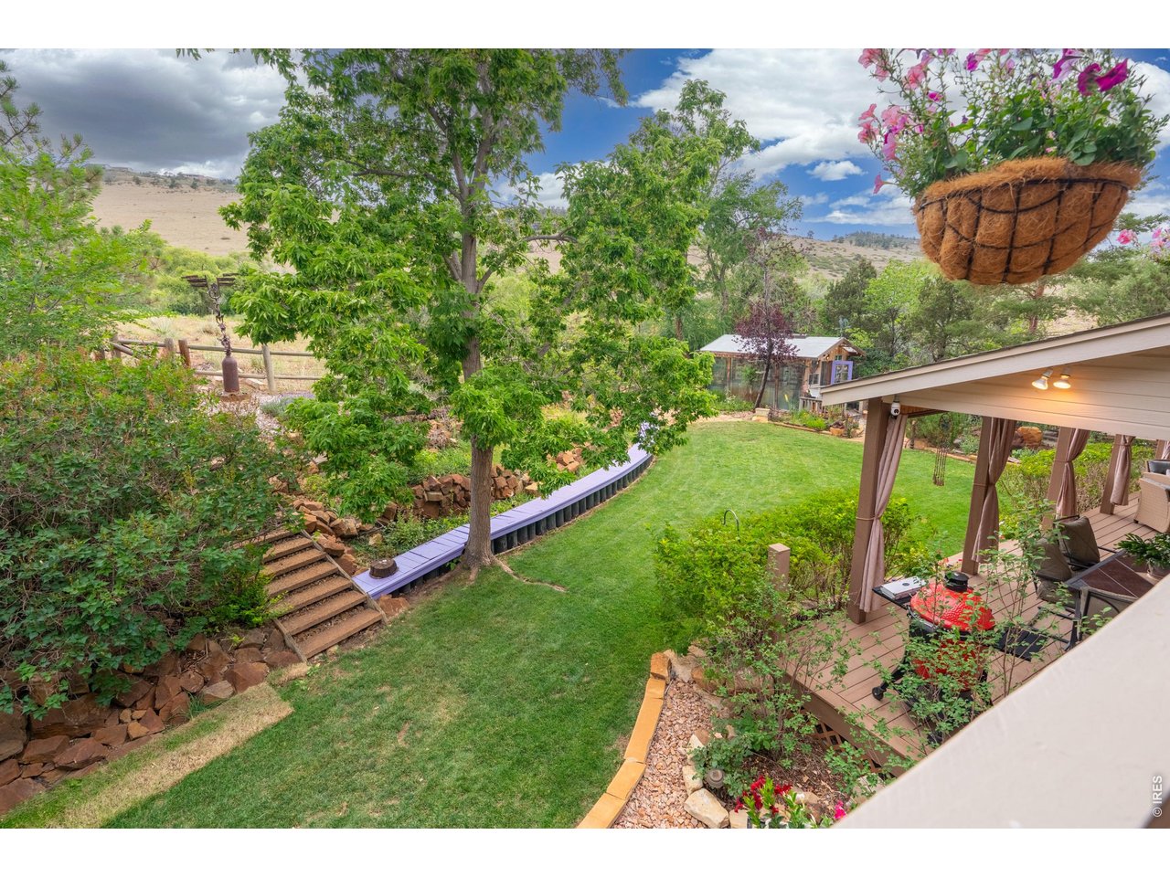 Property Photo 24 View from upper deck overlooking yard, greenhouse and hillside.