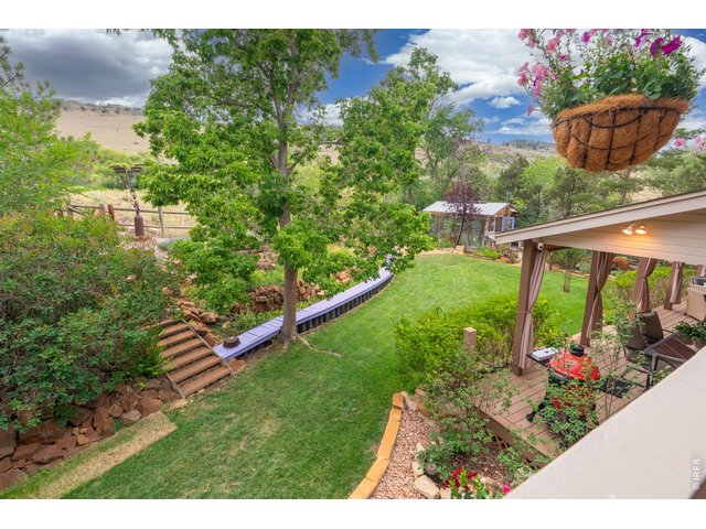 Property Photo 24 View from upper deck overlooking yard, greenhouse and hillside.