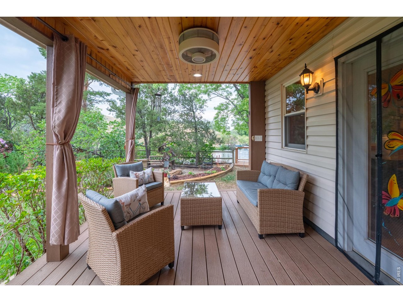 Property Photo 36 Knotty-pine ceiling and drapes shelter the lower covered deck.