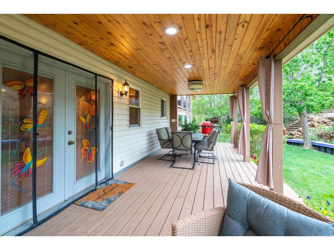 Property Photo 37 French doors open to the lower deck's dining and grilling space.
