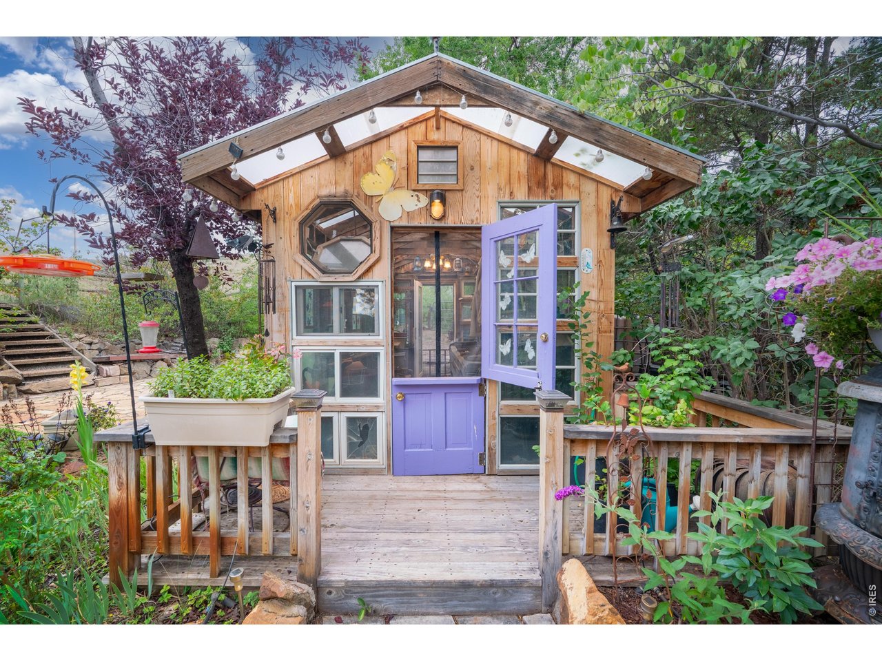 Property Photo 39 Reclaimed windows and a Dutch door give the greenhouse real character.