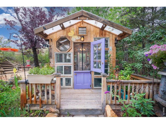 Property Photo 39 Reclaimed windows and a Dutch door give the greenhouse real character.