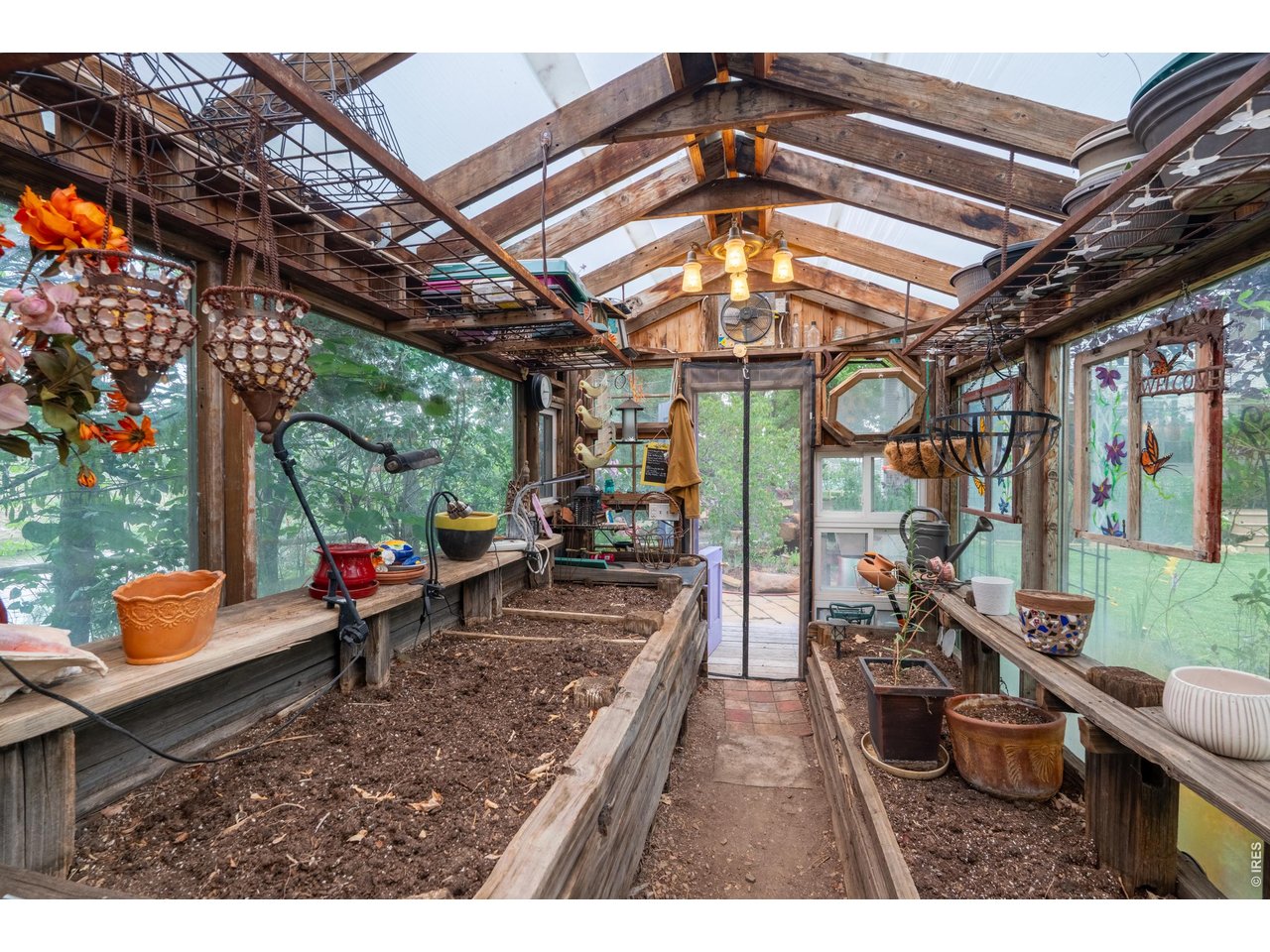 Property Photo 40 Inside the greenhouse raised planting beds, work benches, sink and overhead venting.