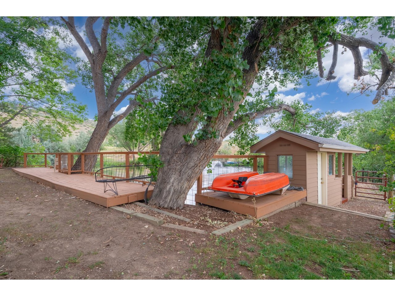 Property Photo 41 Pond-side deck under a mature trees.