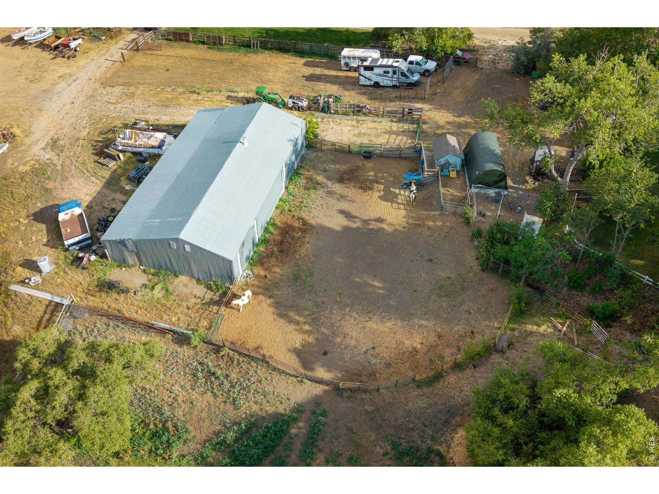Property Photo 47 The 2,460 SF outbuilding with adjoining corrals, loafing shed, and turnout.