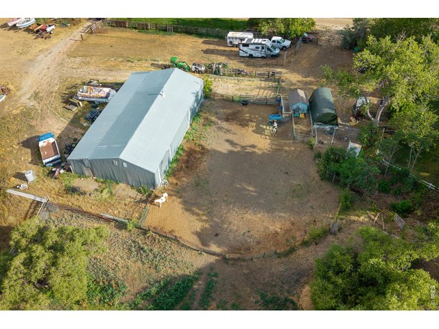 Property Photo 47 The 2,460 SF outbuilding with adjoining corrals, loafing shed, and turnout.