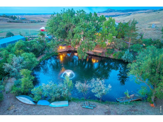 Property Photo 49 The pond lit at dusk, with the decks glowing above the water.