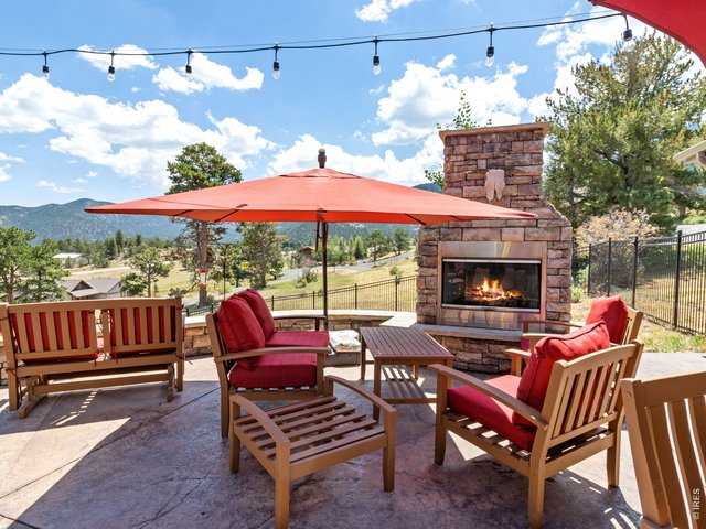 Property Photo 5 Evenings invite you outdoors to the covered patio featuring a hot tub and gas fireplace ideal for summer nights watching hummingbirds or winter evenings spotting elk and deer.
