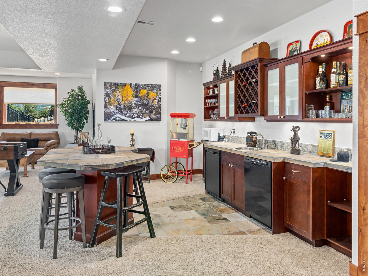 Property Photo 36 The expansive walk out lower level offers the ultimate space for entertaining, featuring a spacious family room with wet bar, game area, two additional bedrooms, and one-and-a-half bathrooms.