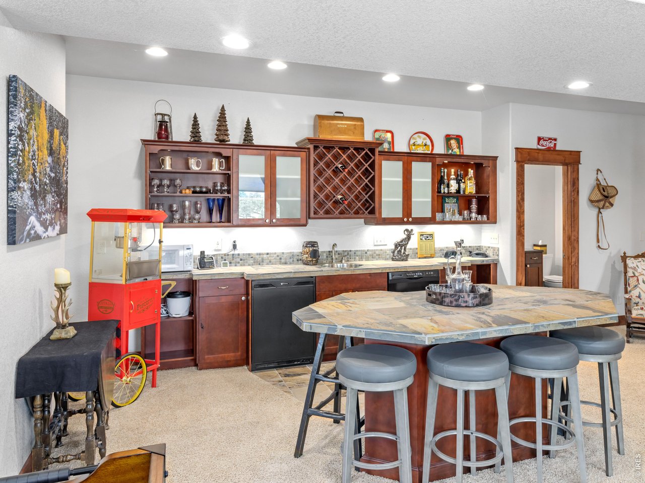 Property Photo 37 The finished lower level is built for fun and flexibility. A full bar area with sink and dishwasher makes hosting effortless.