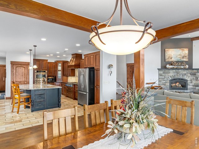 Property Photo 16 The highly sought-after open concept main level offers a seamless flow between the living, dining and kitchen areas creating an inviting space that's perfect for everyday living and entertaining.
