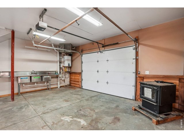 Property Photo 34 Industrial size sinks and garage door of second building which has living area upstairs