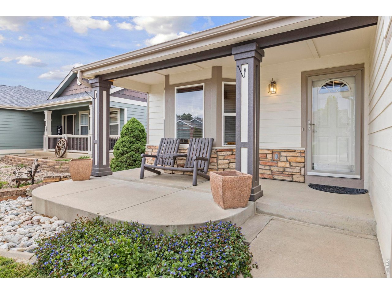 Property Photo 3 Enjoy sitting on your front porch with the chairs and planters included.