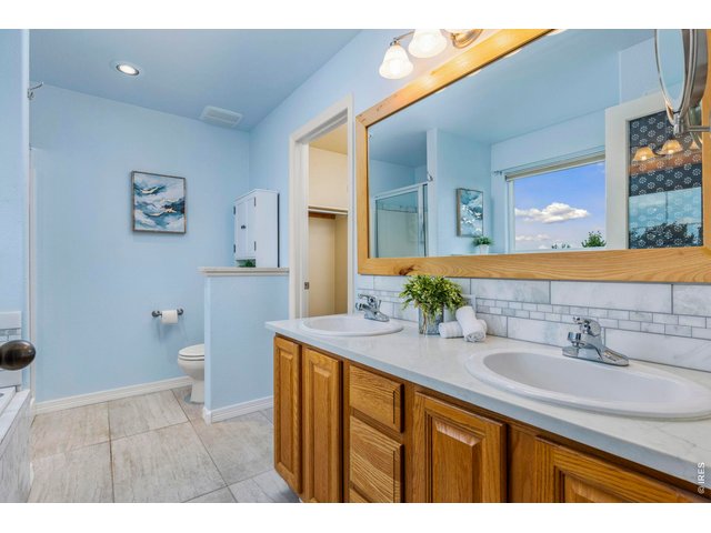 Property Photo 14 primary bathroom with double sinks, tub, shower and walk in closet