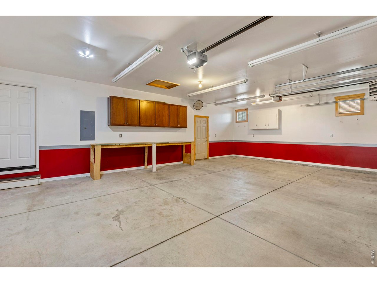 Property Photo 27 Heated 3 car garage with brand new garage door opener on the 2 car side, with phone access.
