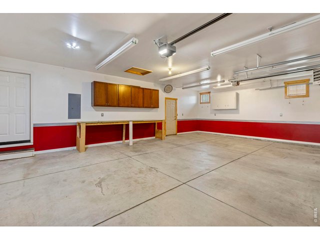 Property Photo 27 Heated 3 car garage with brand new garage door opener on the 2 car side, with phone access.