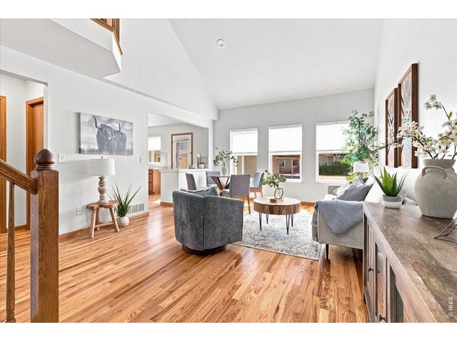 Property Photo 1 View of Great room from the entry. Notice the beautiful, refinished Oak hardwood floors and the vaulted ceiling
