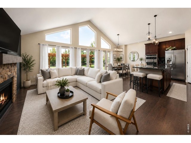 Property Photo 4 Great Room with Expansive Windows to the Back & Vaulted Ceilings!