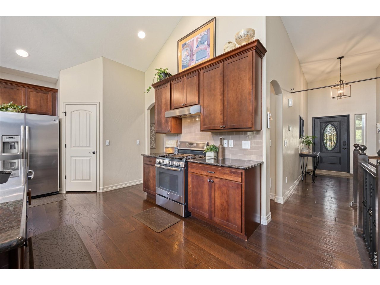 Property Photo 13 View of Entry Way from Kitchen! Vaulted Ceilings & Custom Arch Ways Throughout!