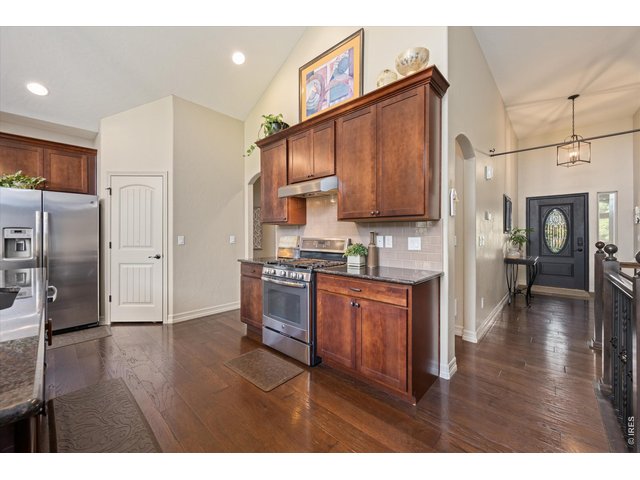 Property Photo 13 View of Entry Way from Kitchen! Vaulted Ceilings & Custom Arch Ways Throughout!