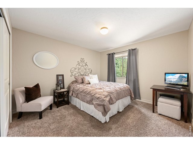 Property Photo 20 Secondary Main Floor Bedroom with Large Window to the Back!