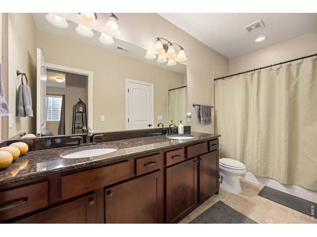 Property Photo 30 Bedroom Opens to Full Bath with Dual Sinks, Tiled Flooring & Tub/Shower and Granite Countertops!