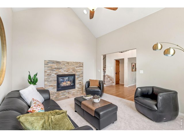 Property Photo 5 Inviting living room with rock fireplace off front entry. (14' x 12')