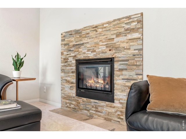 Property Photo 6 Cozy up and read a book by the rock fireplace in living room.