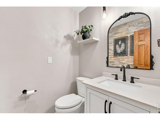 Property Photo 9 Updated powder room on the main level.