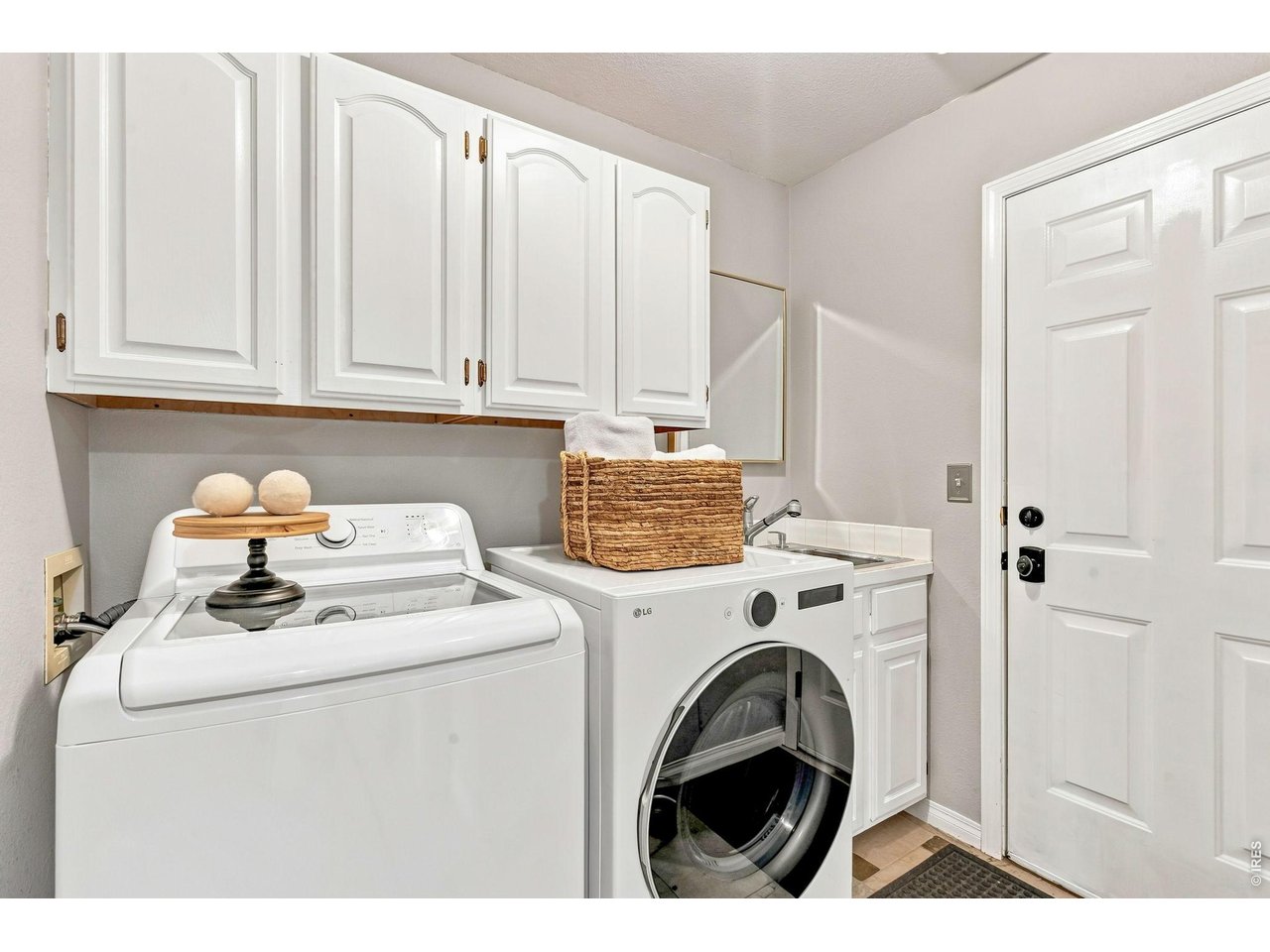 Property Photo 38 Laundry room off garage (7' x 7') features cabinets and sink for convenience. Washer and dryer included.