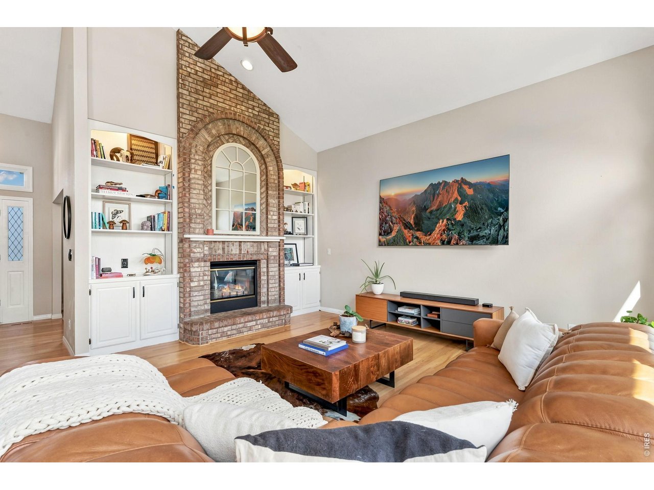Property Photo 11 Striking double-sided brick fireplace that connects the family and living rooms.(20' x 15')
